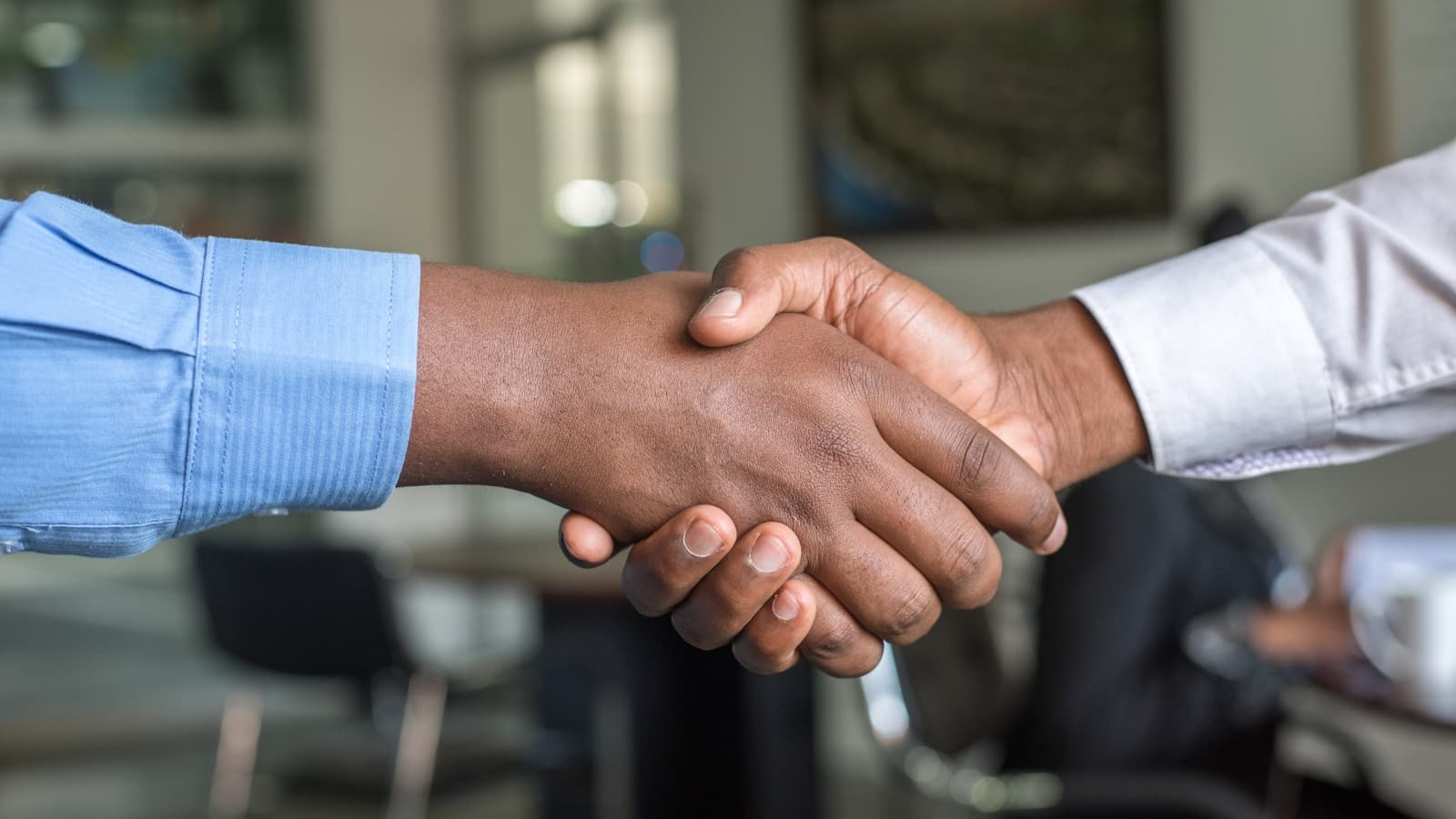Handshake between a business owner and a new customer
