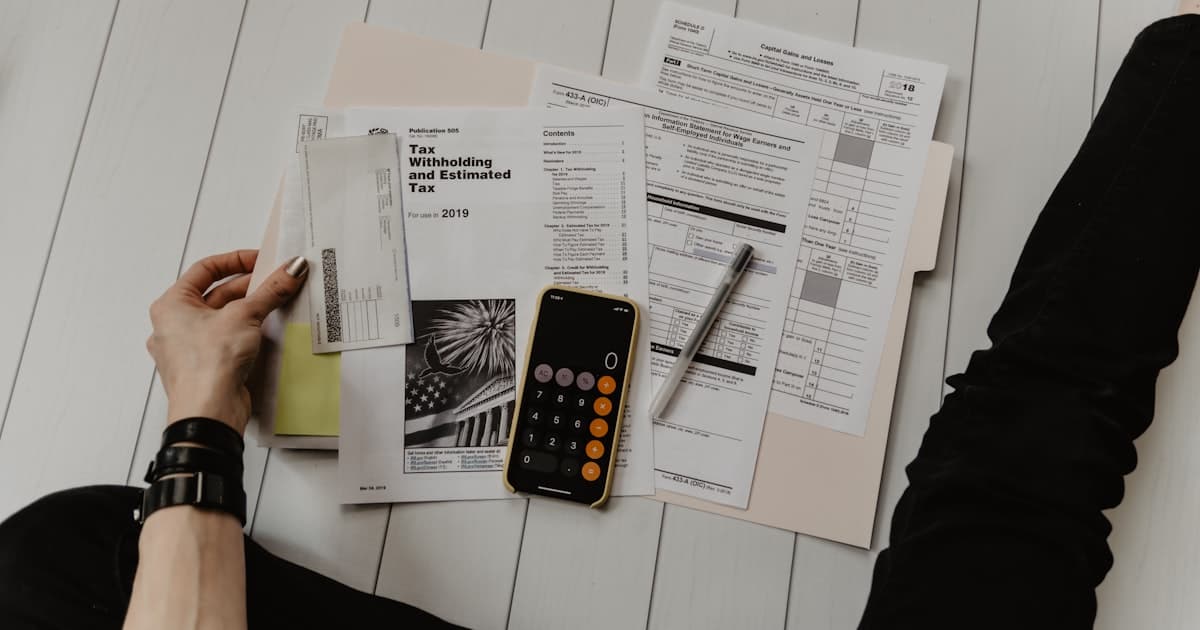 Calculator and paperwork on a desk, representing the calculation of how many minutes an AI receptionist needs